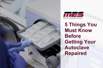 Technician inspecting an open autoclave unit with tools laid out on a workbench, representing pre-repair checks and maintenance planning.